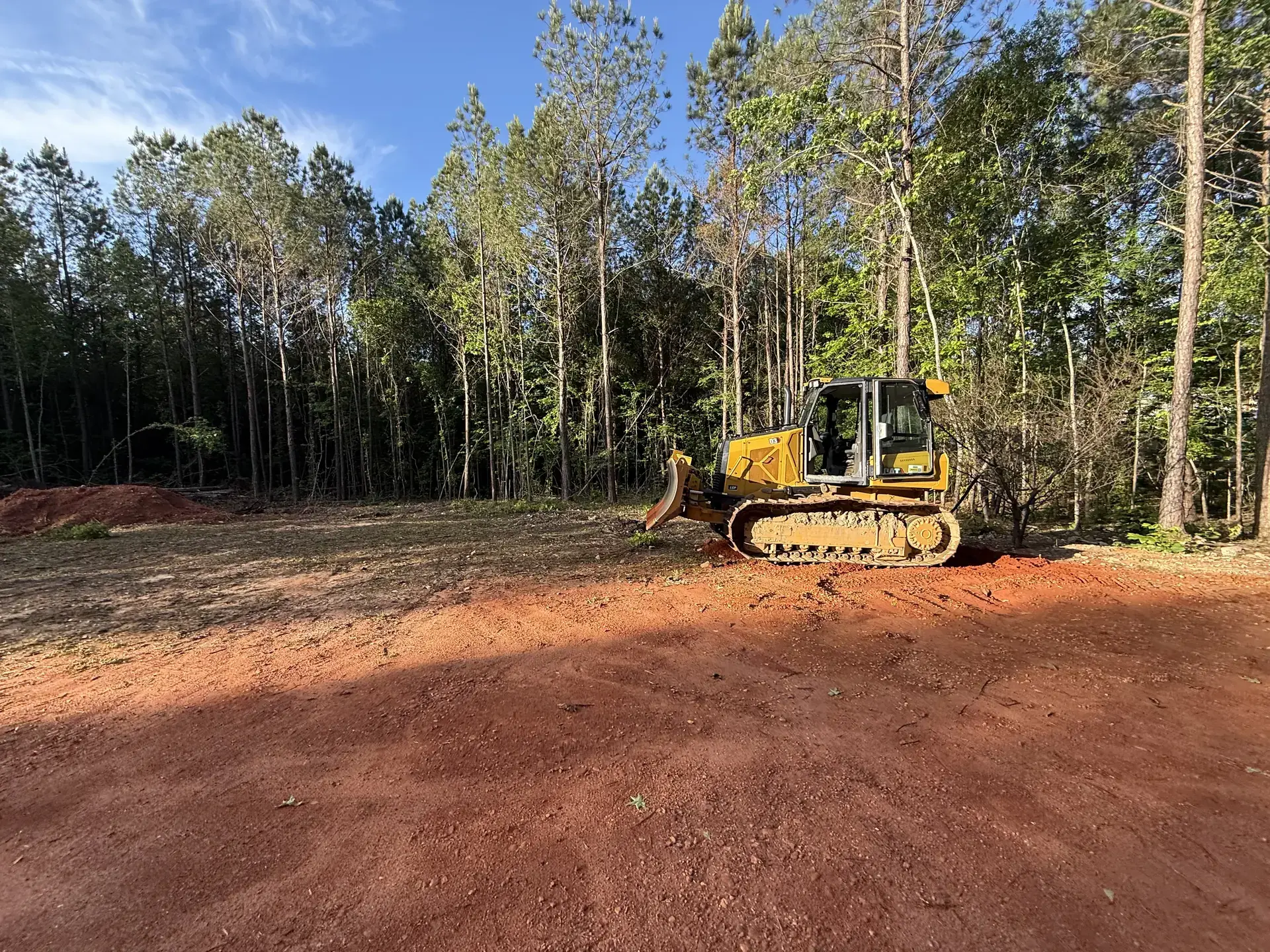 Tracked dozer clearing wooded land for a property owner