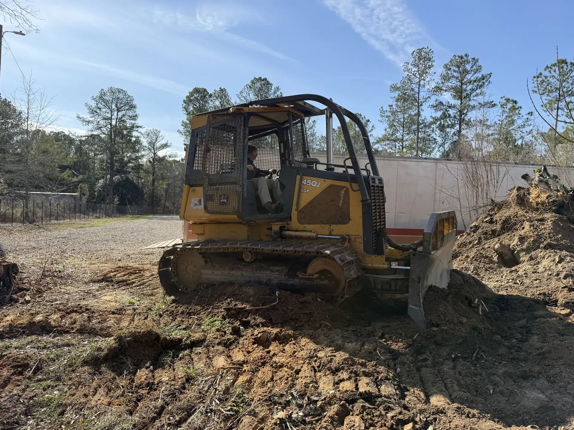 Dozer grading and shaping soil during site preparation