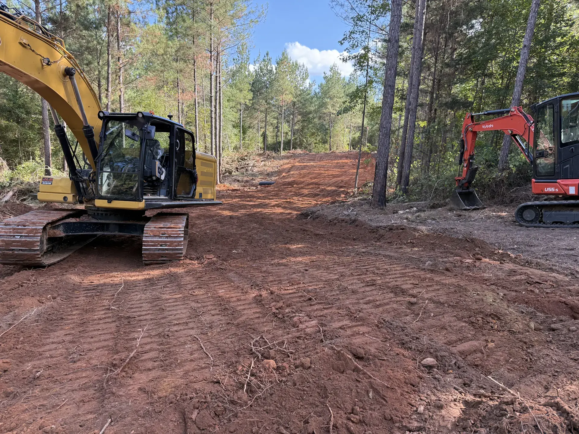 Excavator clearing an East Alabama property for Rhino Landwork