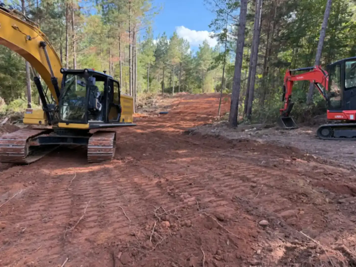 Excavator clearing trees and brush from an East Alabama property
